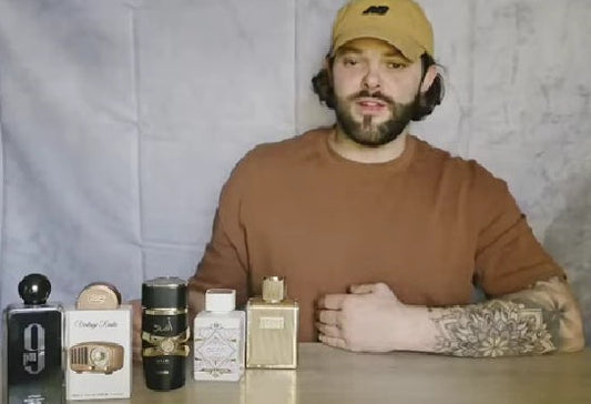 Person sitting at a table with various bottles in front of a plain background